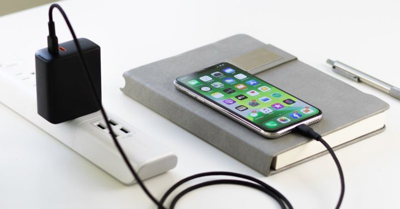 Style Icons - Recharging smartphone placed on diary on table
